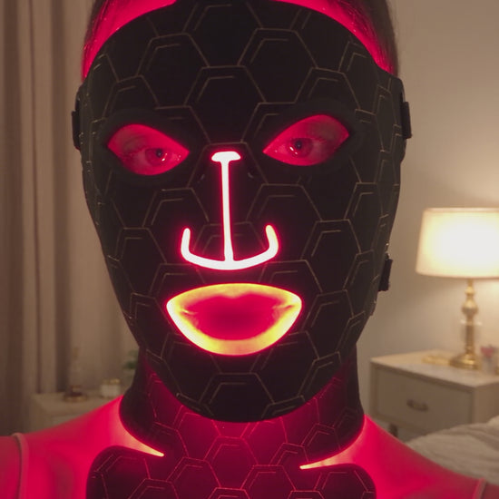 Radiance Revive 7-in-1 LED face mask demo: black hexagon silicone mask glowing red during an evening skincare routine