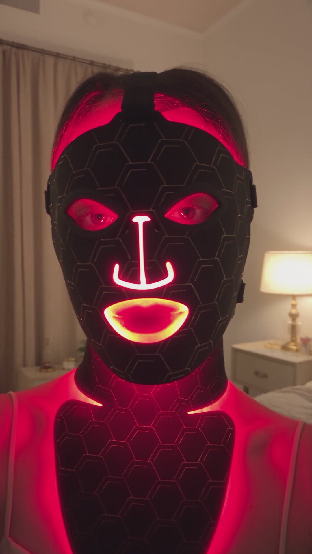 Radiance Revive 7-in-1 LED face mask demo: black hexagon silicone mask glowing red during an evening skincare routine